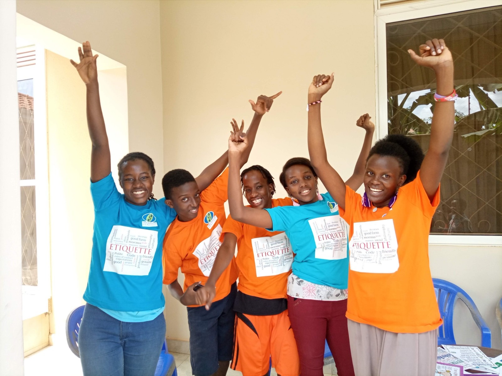 Children raising hands in class