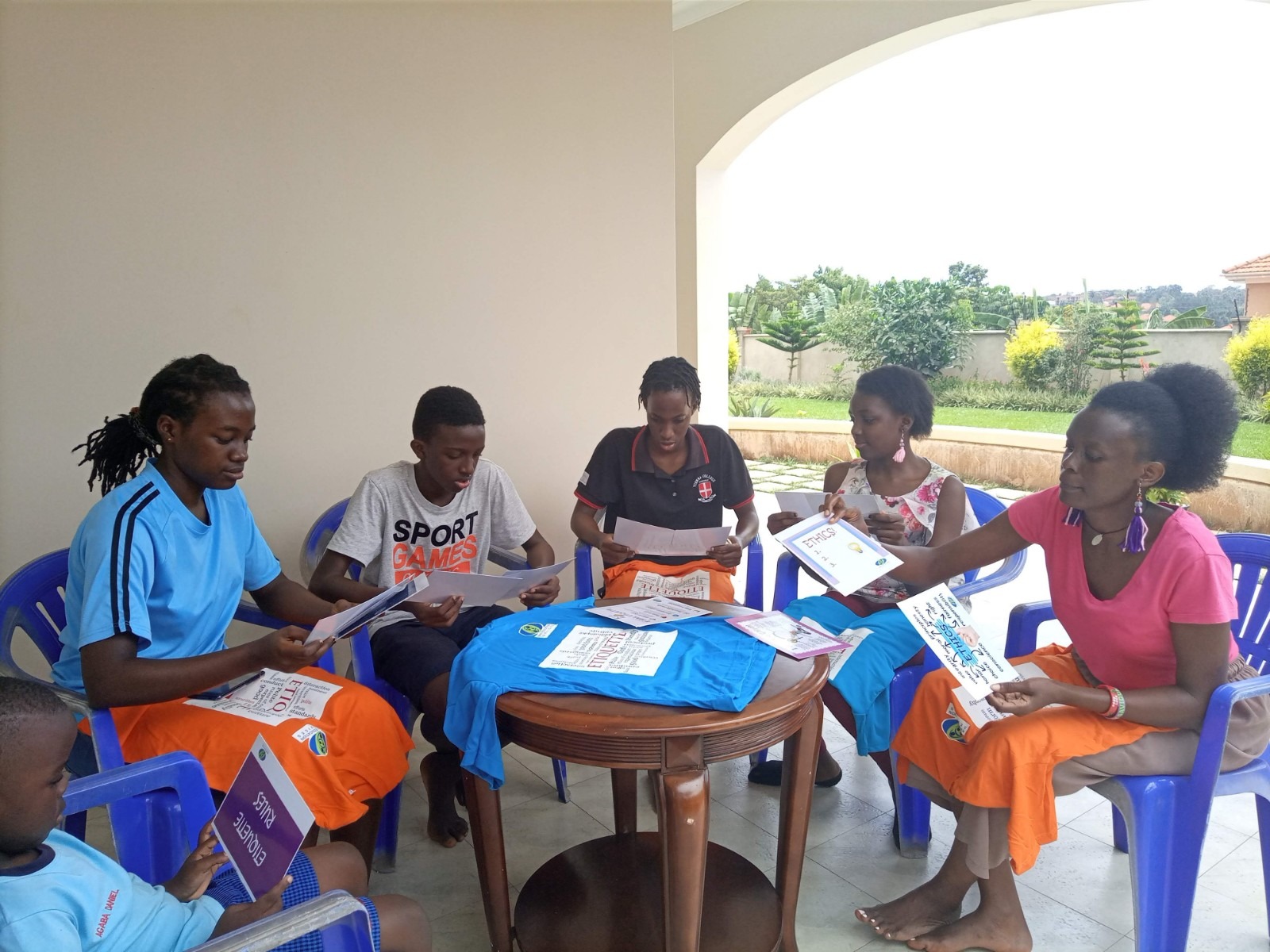 Staff reading books with children